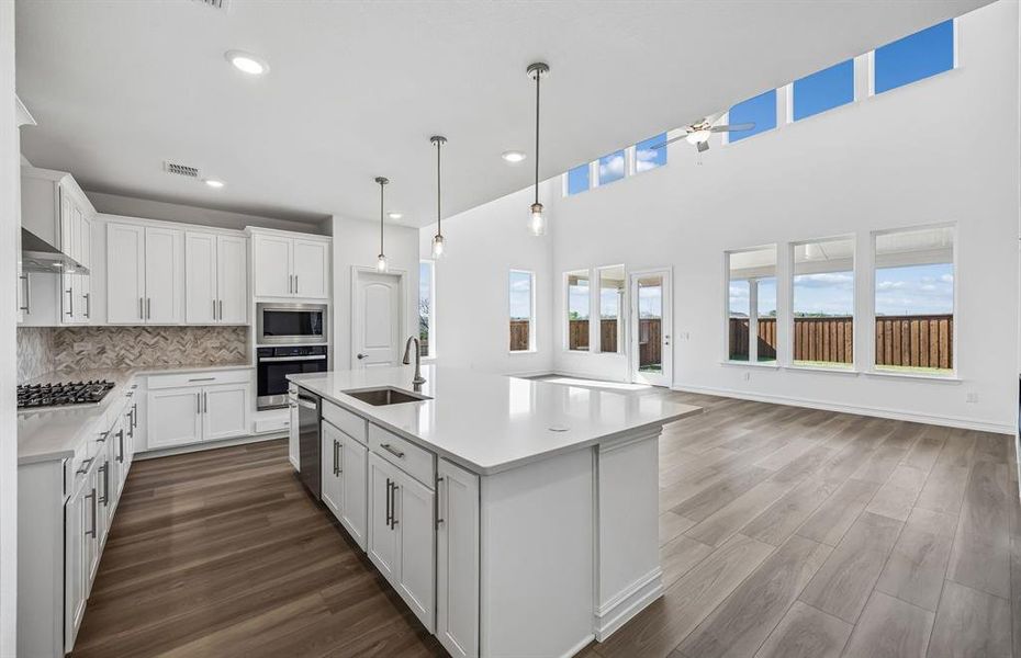 Large island in kitchen overlooking gathering area Large island in kitchen overlooking gathering area