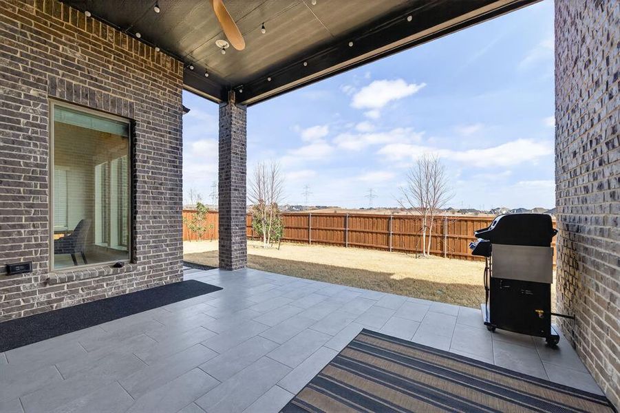 Extended covered patio with tile flooring and recessed lighting. Extended covered patio with tile flooring and recessed lighting.