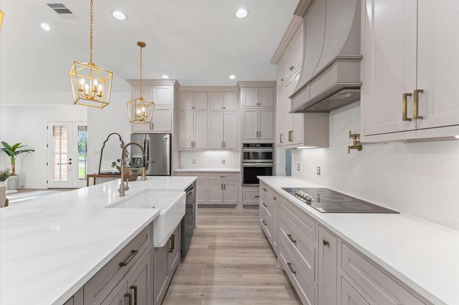 The kitchen is a chef’s dream with custom cabinetry, upgraded finishes, and a large island perfect for gatherings. The kitchen is a chef’s dream with custom cabinetry, upgraded finishes, and a large island perfect for gatherings.