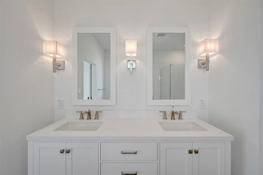 Freestanding vanity with dual sinks and brushed nickle fixtures Freestanding vanity with dual sinks and brushed nickle fixtures