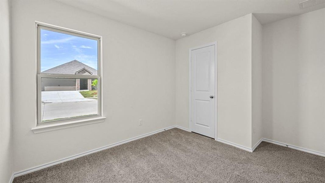 Unfurnished room featuring baseboards and carpet floors