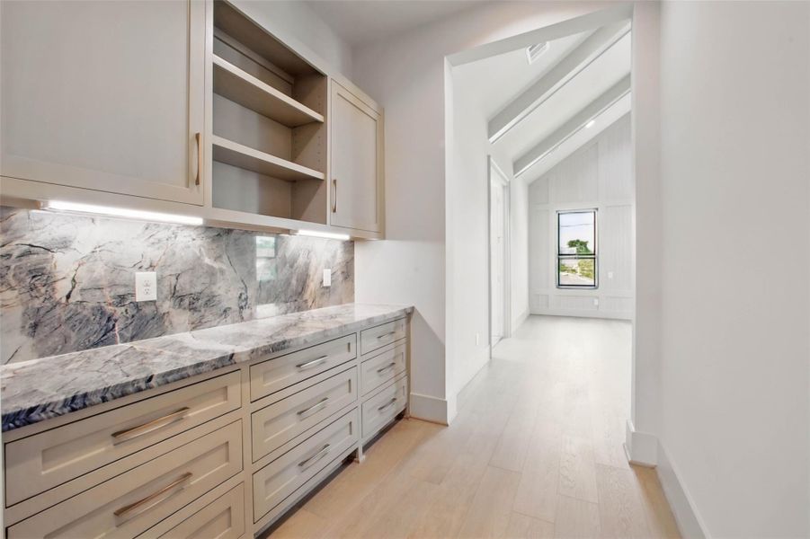Sample of builder's previous construction. This home will have an upstairs primary suite entrance similar to the layout pictured here. Makes a perfect coffee bar area and provides additional storage. Buyer still has time to select finishes.