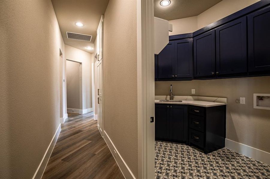 Laundry room featuring sink, dark hardwood / wood-style flooring, cabinets, and hookup for a washing machine