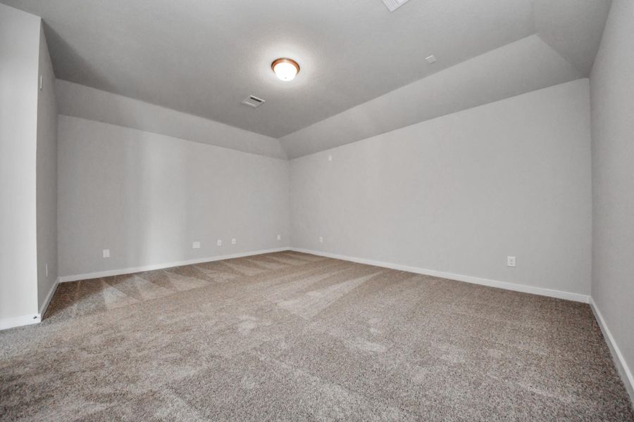 Take another look at the spacious media room, perfect for movie nights.