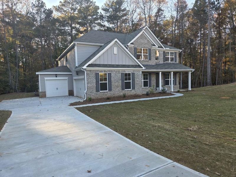 Front exterior of a new home in Ruby Creek Estates, Atlanta, GA, highlighting curb appeal (Image 15). Front exterior of a new home in Ruby Creek Estates, Atlanta, GA, highlighting curb appeal (Image 15).