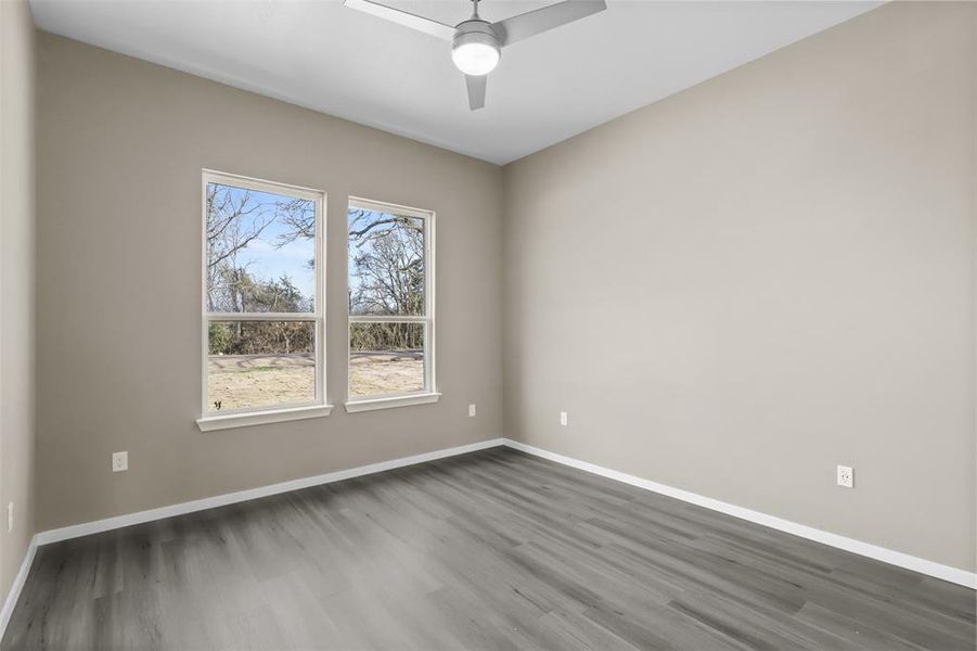 Spare room with ceiling fan and dark hardwood / wood-style floors