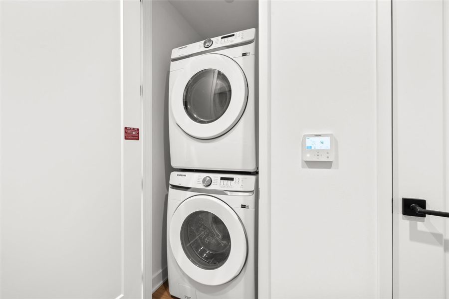 Representative Photo. Laundry closet with stacked washer and dryer included in unit.
