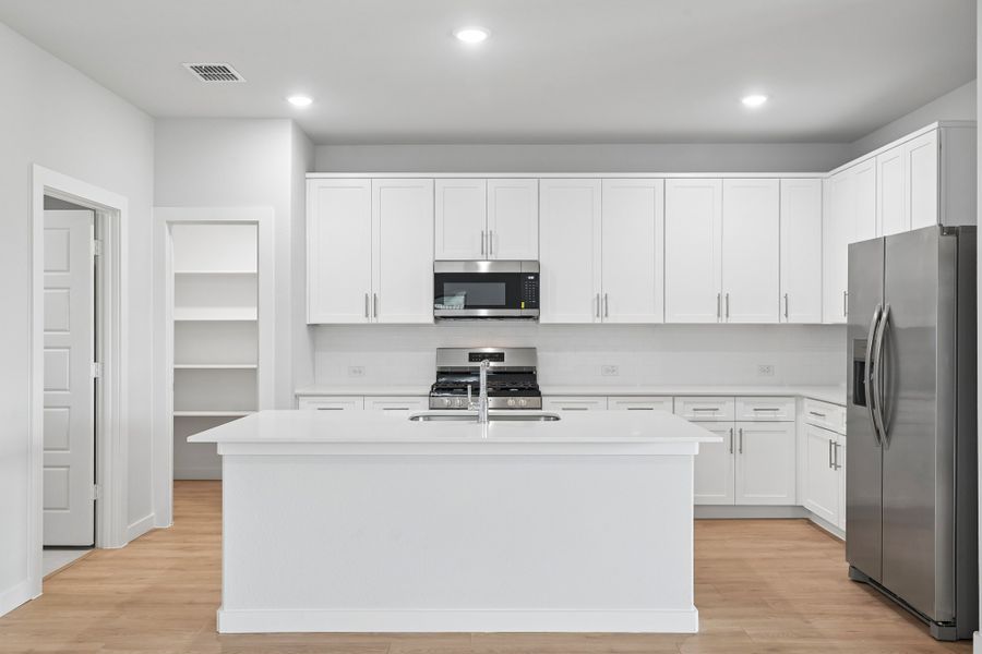 Kitchen in the Hayden home plan by Trophy Signature Homes
