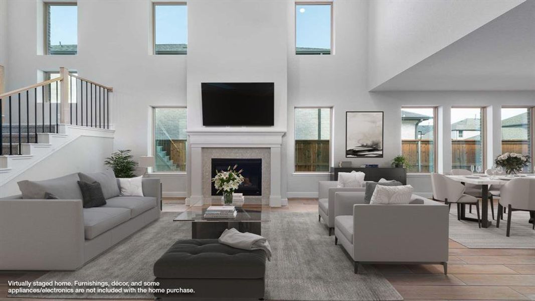 Living room featuring a high ceiling and light wood-type flooring