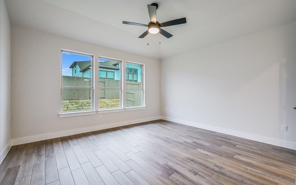 Unfurnished room with light wood-type flooring and a ceiling fan