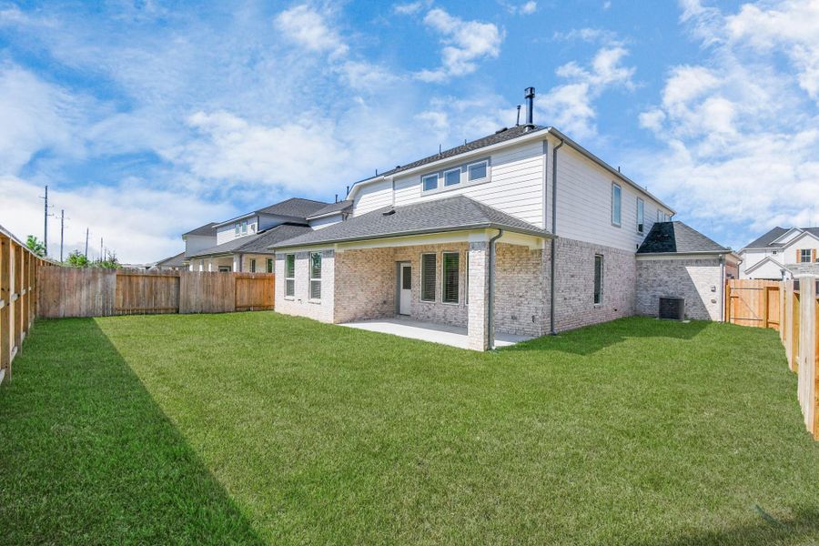 Experience outdoor living at its finest on this expansive covered patio, thoughtfully designed for BBQs and delightful outdoor dining