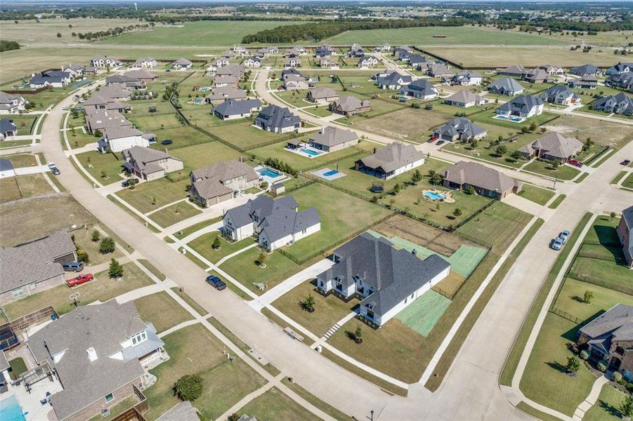 Aerial view of property and surrounding area with nearby suburban area Aerial view of property and surrounding area with nearby suburban area