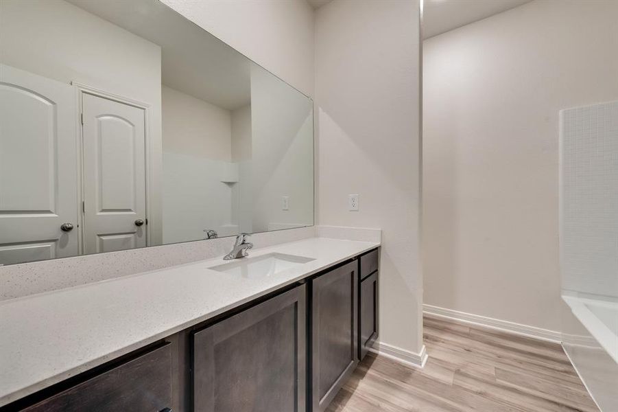 Bathroom with  shower combination, wood-type flooring, and vanity