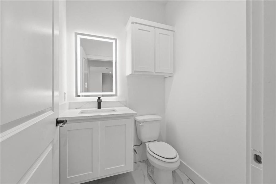 Bathroom featuring vanity and toilet