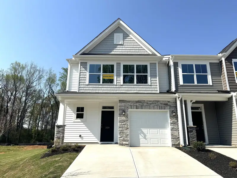 Front exterior of a new home in East Main Townes, Spartanburg, SC, highlighting curb appeal (Image 1). Front exterior of a new home in East Main Townes, Spartanburg, SC, highlighting curb appeal (Image 1).