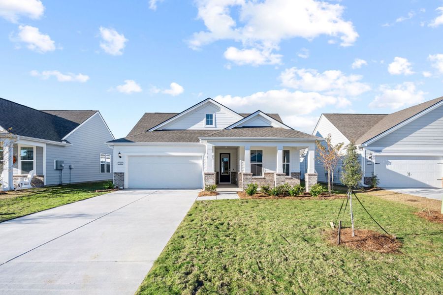 Front exterior of a new home in Sun City Hilton Head, Bluffton, SC, highlighting curb appeal (Image 1). Front exterior of a new home in Sun City Hilton Head, Bluffton, SC, highlighting curb appeal (Image 1).