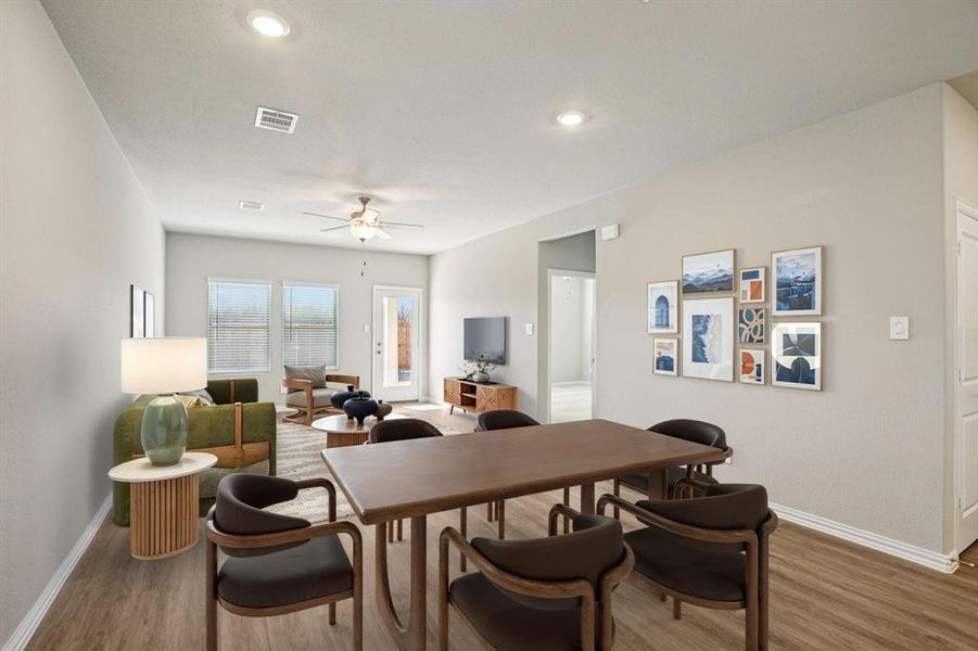 Dining area featuring light wood-style floors, a ceiling fan, and recessed lighting