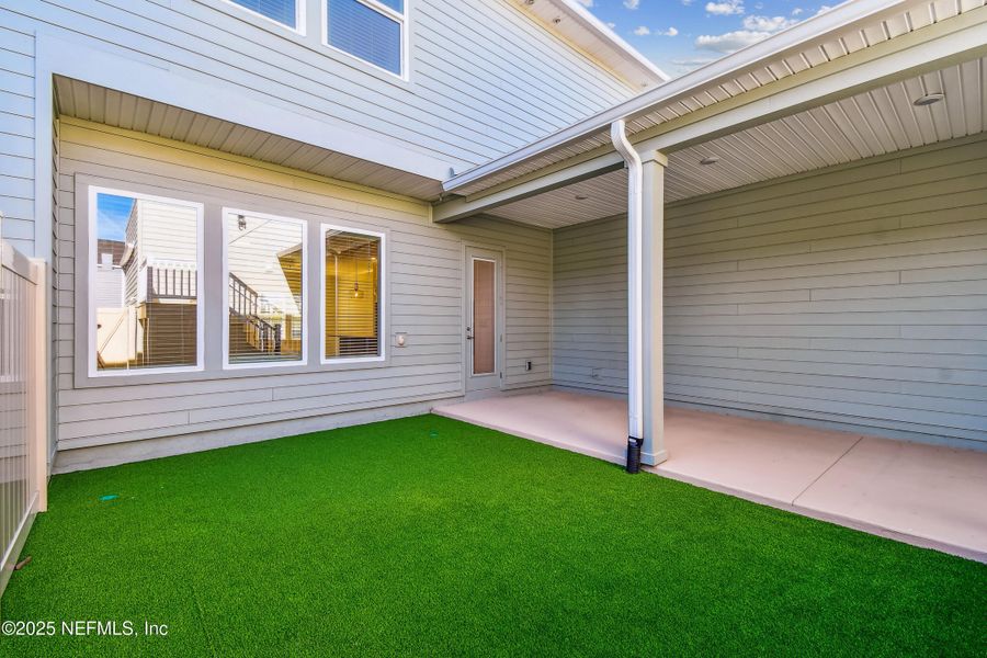 Exterior details and patio area of a home in Seven Pines 24' Rear Entry Townhomes, Jacksonville (Image 17).