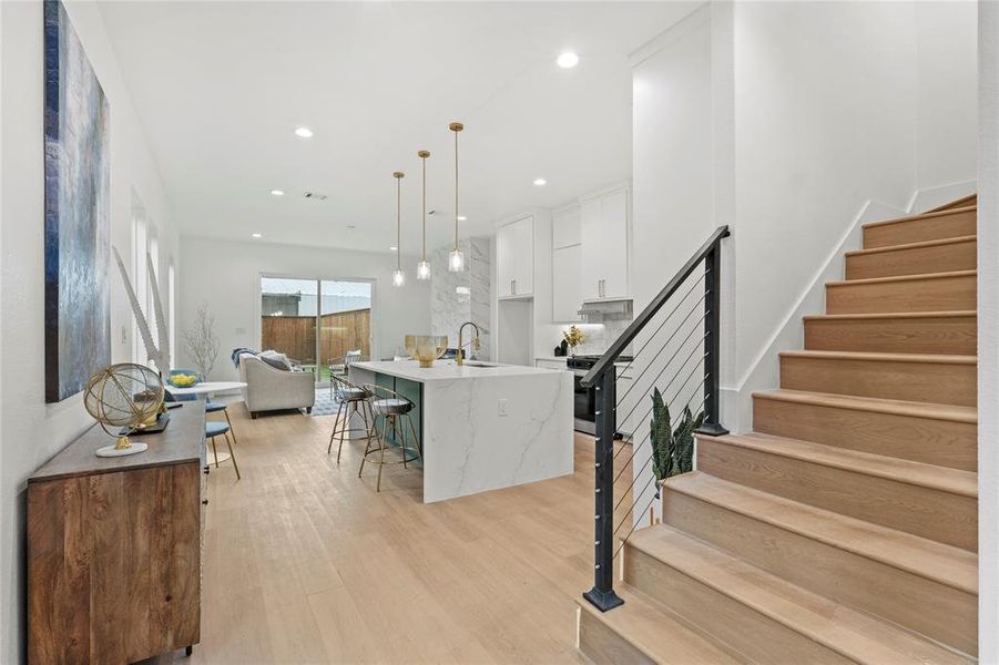Stairs featuring wood finished floors and recessed lighting