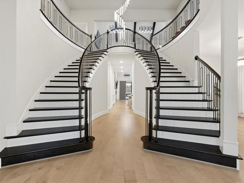 Grand bifurcated staircase featuring dark wood treads and handrails with contemporary metal balusters Grand bifurcated staircase featuring dark wood treads and handrails with contemporary metal balusters