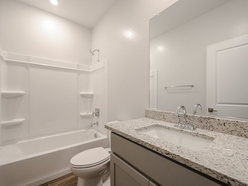 A bathroom with a marble countertop.