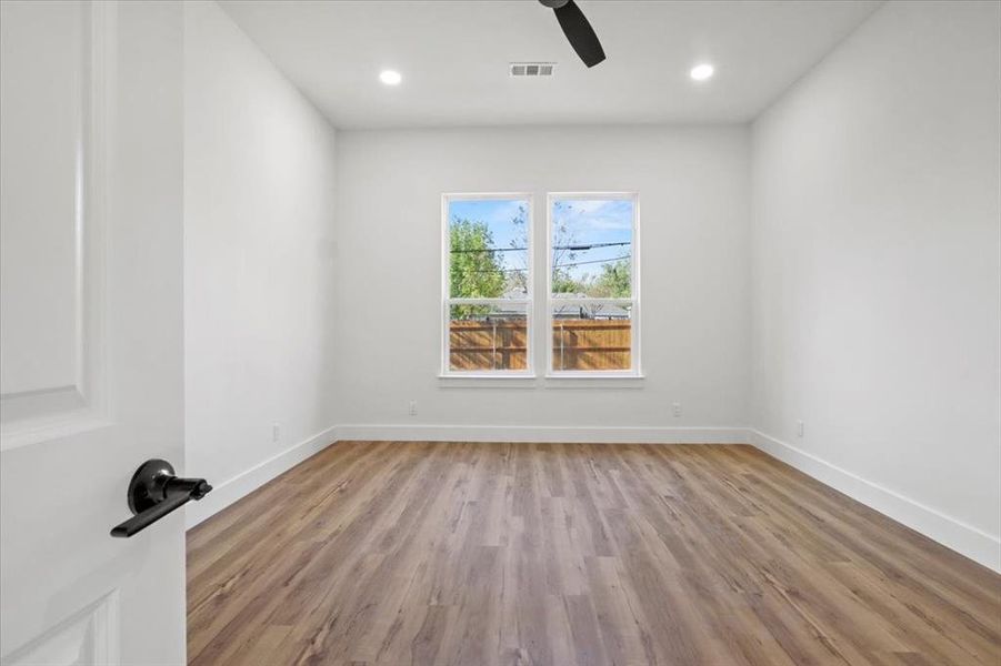 Spare room with light wood-style floors, recessed lighting, and a ceiling fan