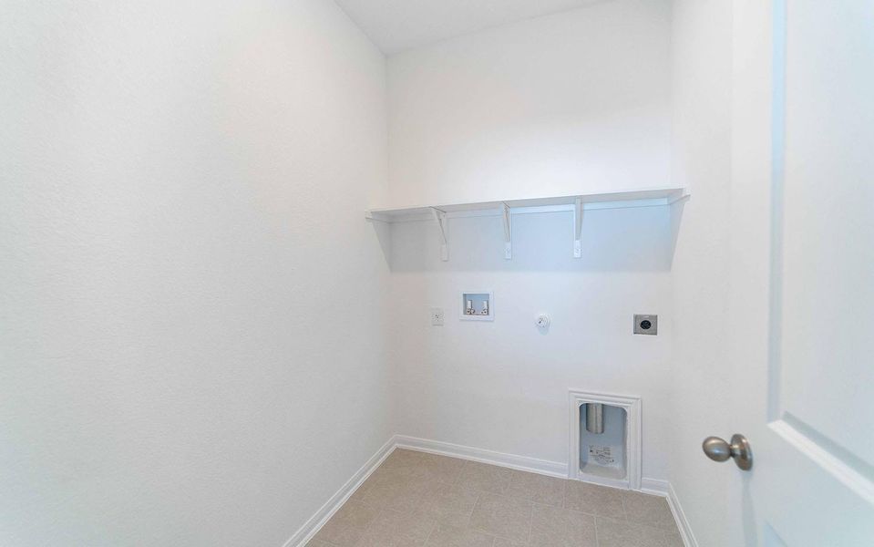 Washroom featuring hookup for a gas dryer, washer hookup, and hookup for an electric dryer Washroom featuring hookup for a gas dryer, washer hookup, and hookup for an electric dryer