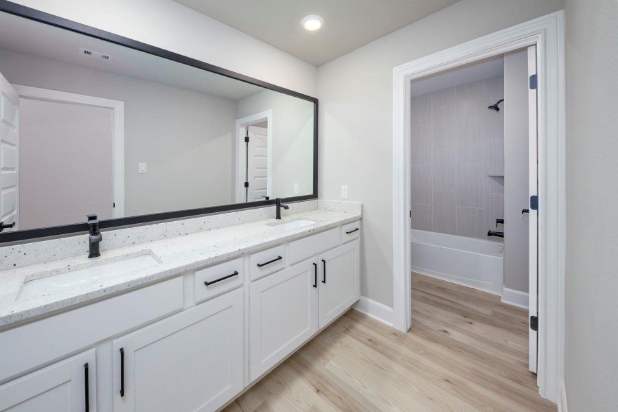 Each bathroom has expansive vanities offering an abundance of storage below. Each bathroom has expansive vanities offering an abundance of storage below.