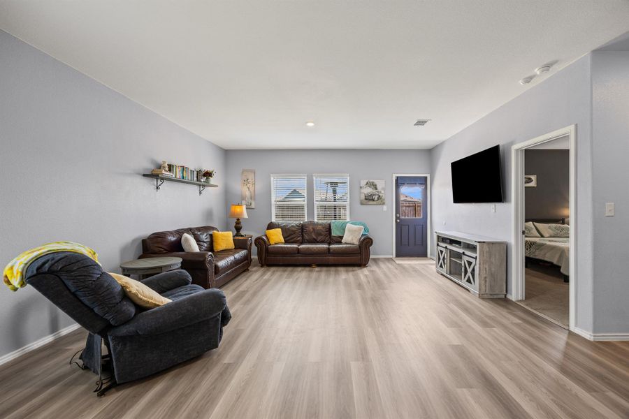 Living room featuring LVP flooring and access to the backyard Living room featuring LVP flooring and access to the backyard
