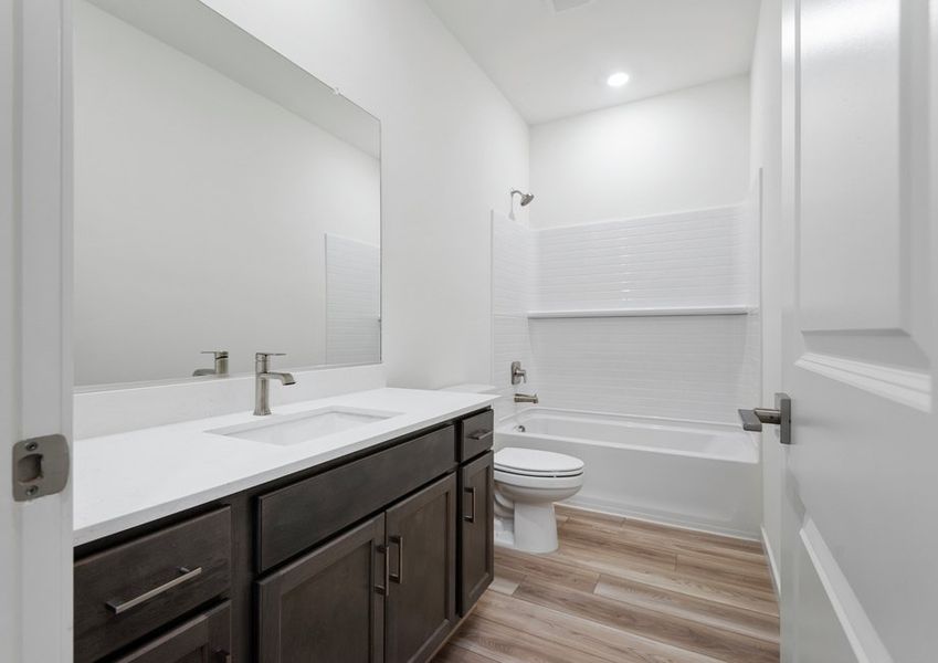 The guest bathroom has tons of counter space for guests or family to get ready.