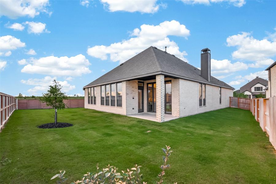 Rear view of the home and covered patio.