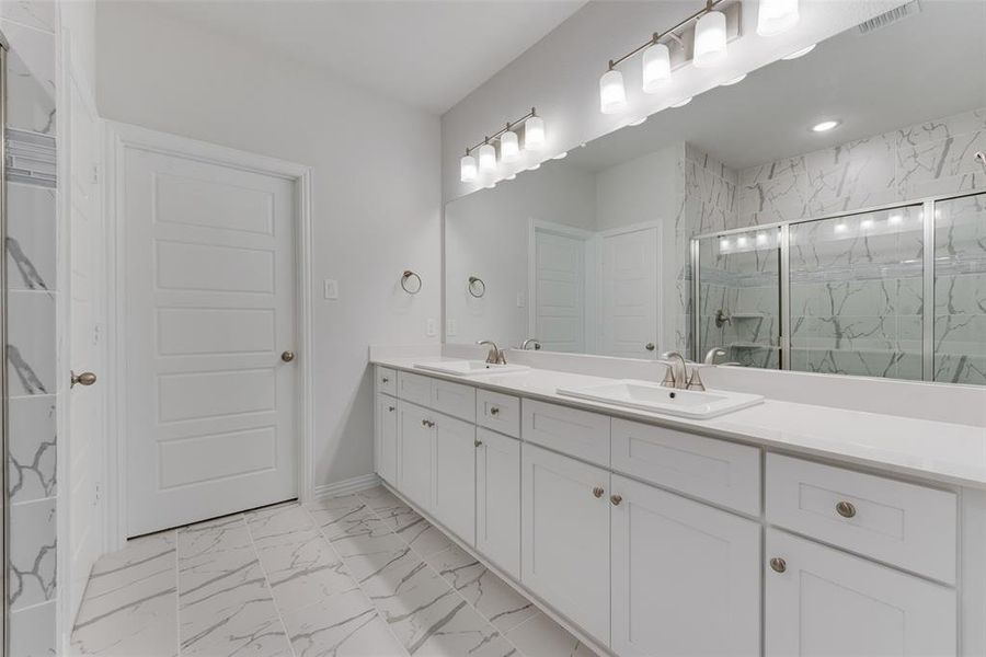 Bathroom with tile patterned flooring and dual bowl vanity