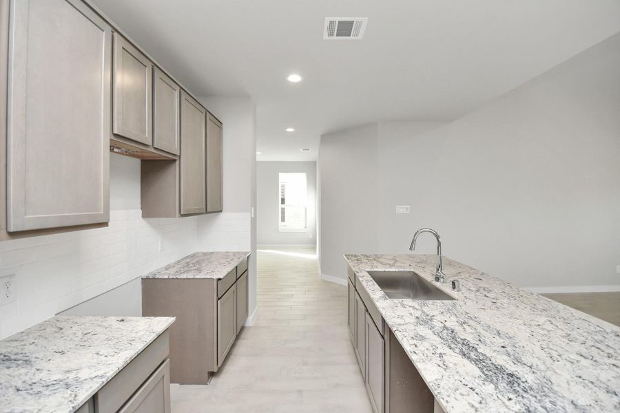 Take another look at the extended counter area that adds practicality to the stylish design. Sample photo of completed home with similar floor plan. Actual colors and selections may vary.