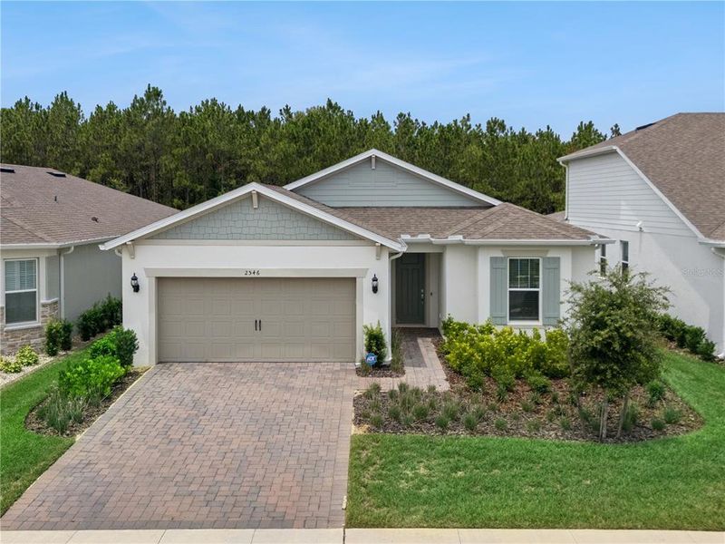 Front exterior of a new home in , Minneola, FL, highlighting curb appeal (Image 1). Front exterior of a new home in , Minneola, FL, highlighting curb appeal (Image 1).