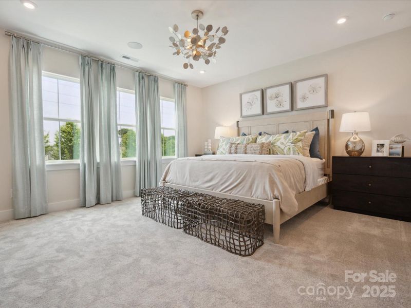 A wall of windows adds warmth and light to the space. *Model Photos | Actual finishes, structural selections, and orientation may vary.