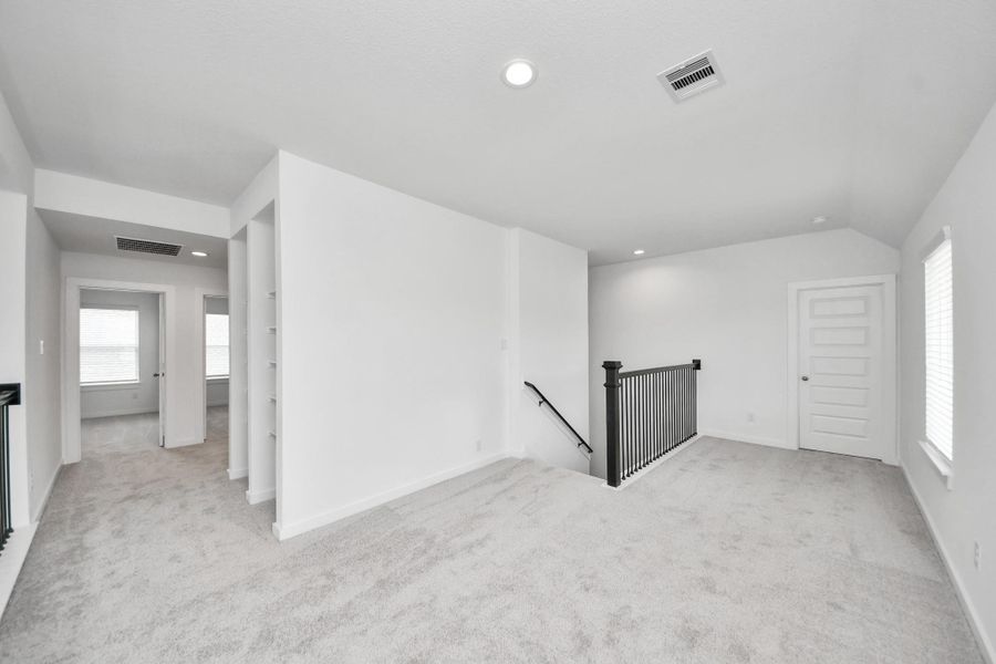 Come upstairs and enjoy a day of leisure in this fabulous game room! This is the perfect hangout spot or adult game room! Features plush carpet, high ceilings, custom paint and windows for plenty of natural light. Come upstairs and enjoy a day of leisure in this fabulous game room! This is the perfect hangout spot or adult game room! Features plush carpet, high ceilings, custom paint and windows for plenty of natural light.