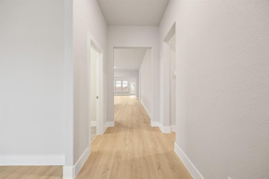 Corridor with light wood-type flooring