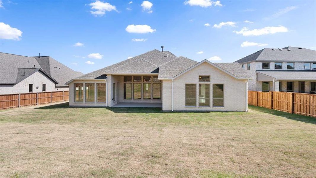 Rear view of house with a lawn