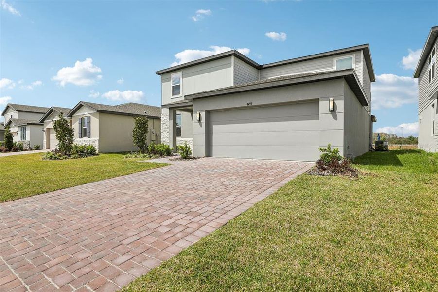 Front exterior of a new home in The Meadow at Crossprairie, St. Cloud, FL, highlighting curb appeal (Image 24).