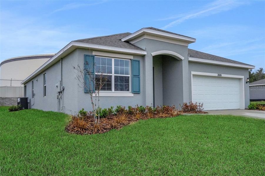 Front exterior of a new home in Seaport Village, Tavares, FL, highlighting curb appeal (Image 16). Front exterior of a new home in Seaport Village, Tavares, FL, highlighting curb appeal (Image 16).