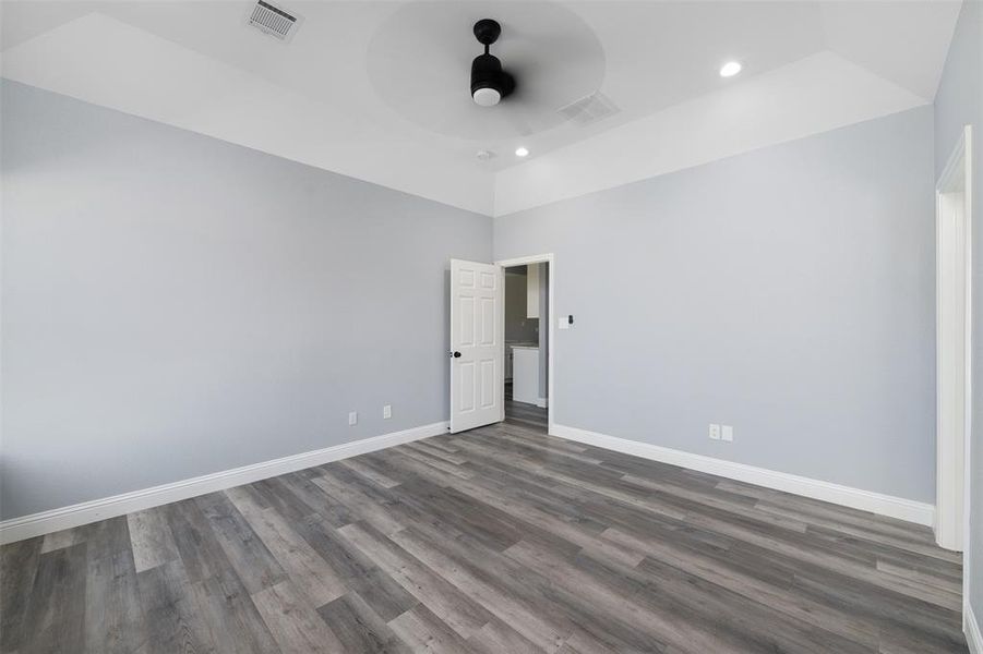 Empty room featuring dark wood-style flooring, recessed lighting, and ceiling fan Empty room featuring dark wood-style flooring, recessed lighting, and ceiling fan