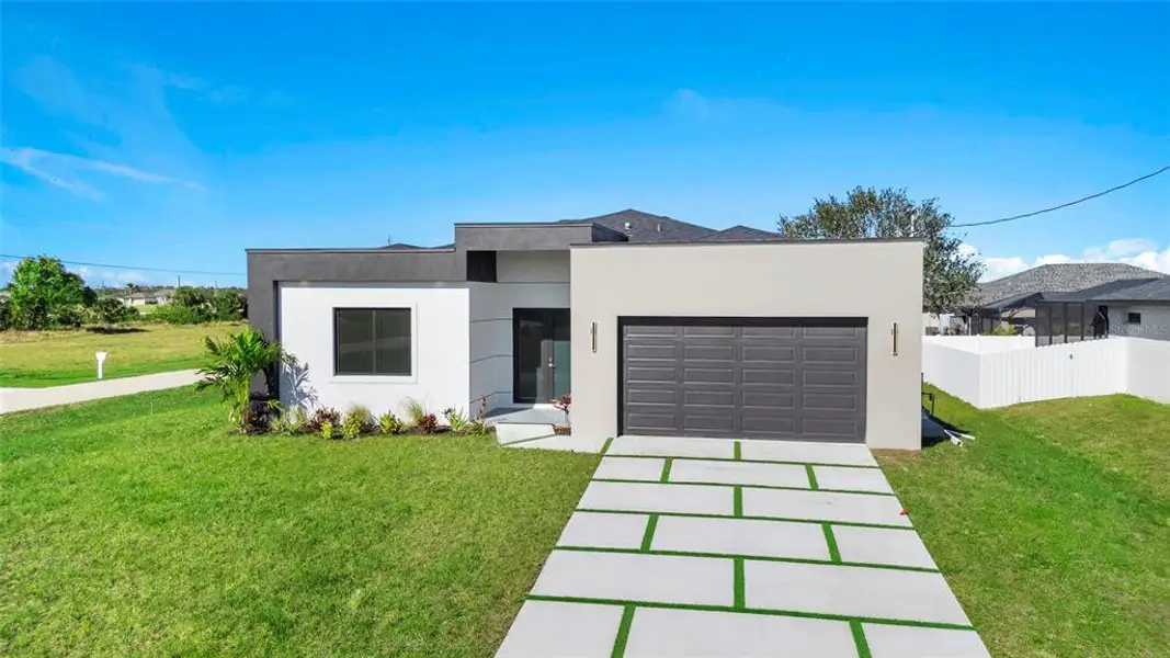 Front exterior of a new home in , Cape Coral, FL, highlighting curb appeal (Image 27). Front exterior of a new home in , Cape Coral, FL, highlighting curb appeal (Image 27).