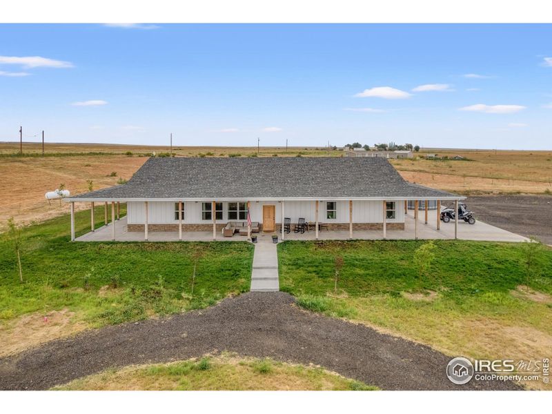 Front exterior of a new home in , Weldona, CO, highlighting curb appeal (Image 27).