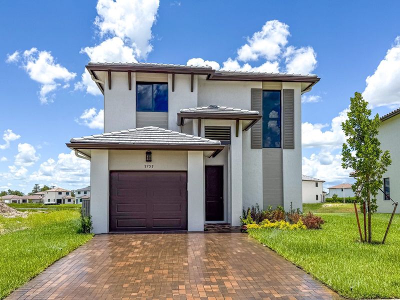 Front exterior of a new home in Maple Ridge, Ave Maria, FL, highlighting curb appeal (Image 1).