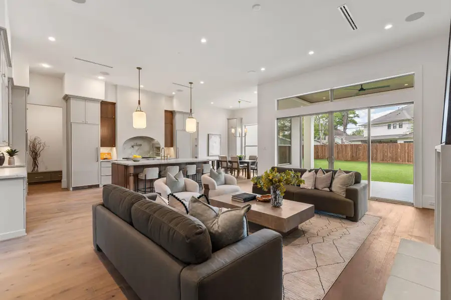 Designed for seamless living, the open-concept layout connects the kitchen, breakfast area, and living room. Expansive sliding glass doors provide abundant natural light and offer a direct connection to the outdoor space.