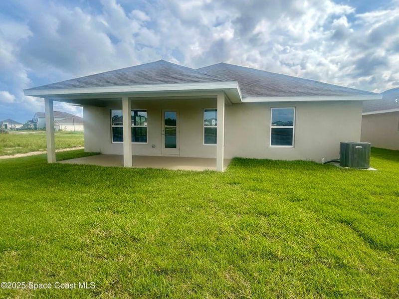 Exterior details and patio area of a home in St. John Preserve, Palm Bay (Image 2).