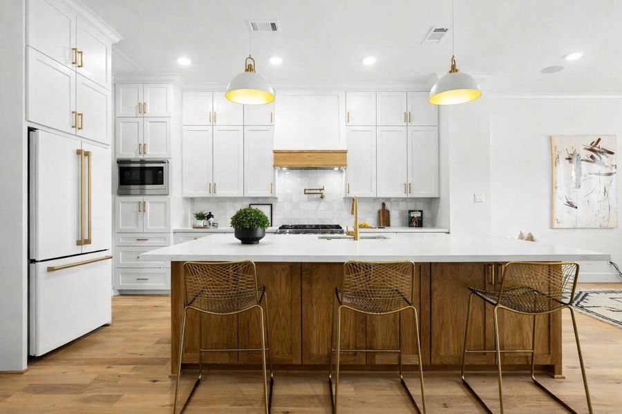 Sleek built-in appliances add a sophisticated touch, merging luxury and modern functionality.