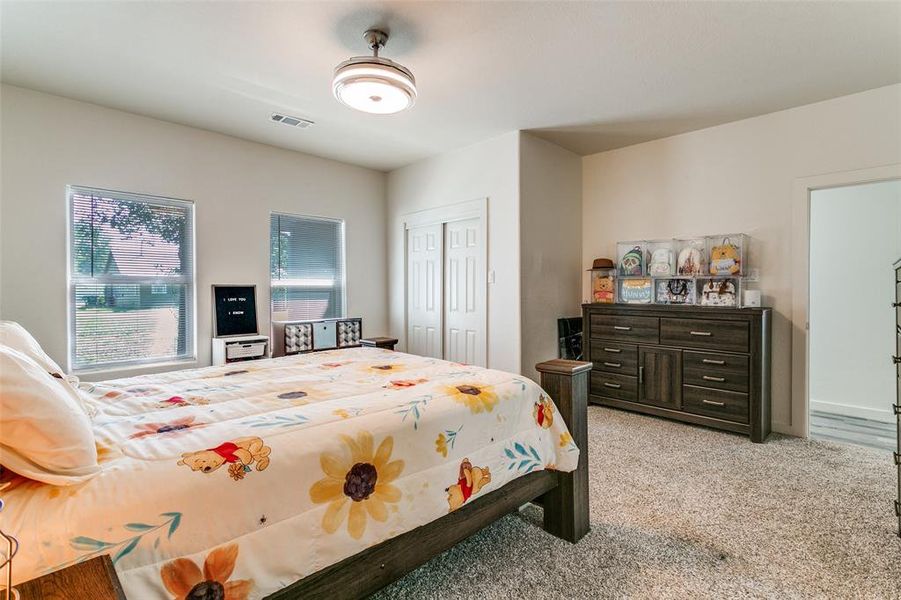 Bedroom with light carpet and a closet Bedroom with light carpet and a closet