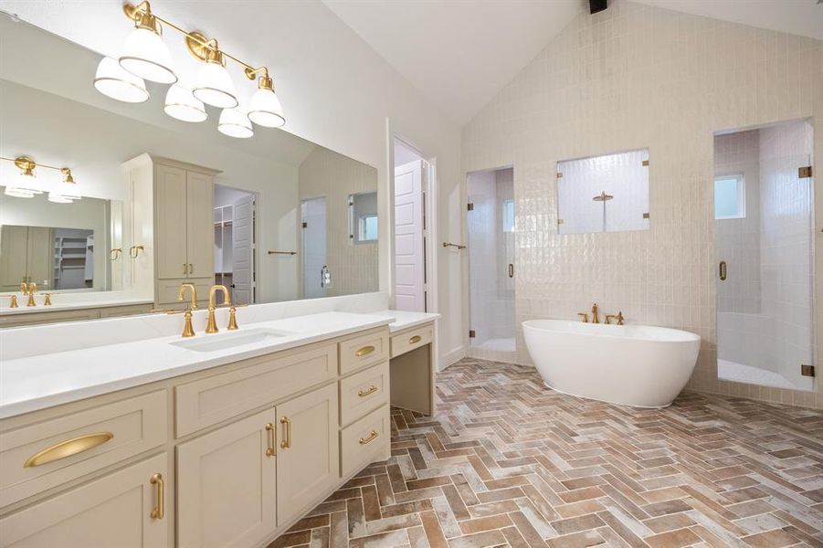 Bathroom with a stall shower, a freestanding bath, vanity, high vaulted ceiling, and brick patterned floors