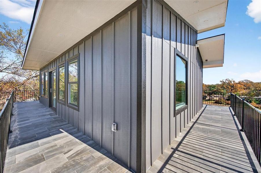 View of home's exterior featuring board and batten siding and a balcony